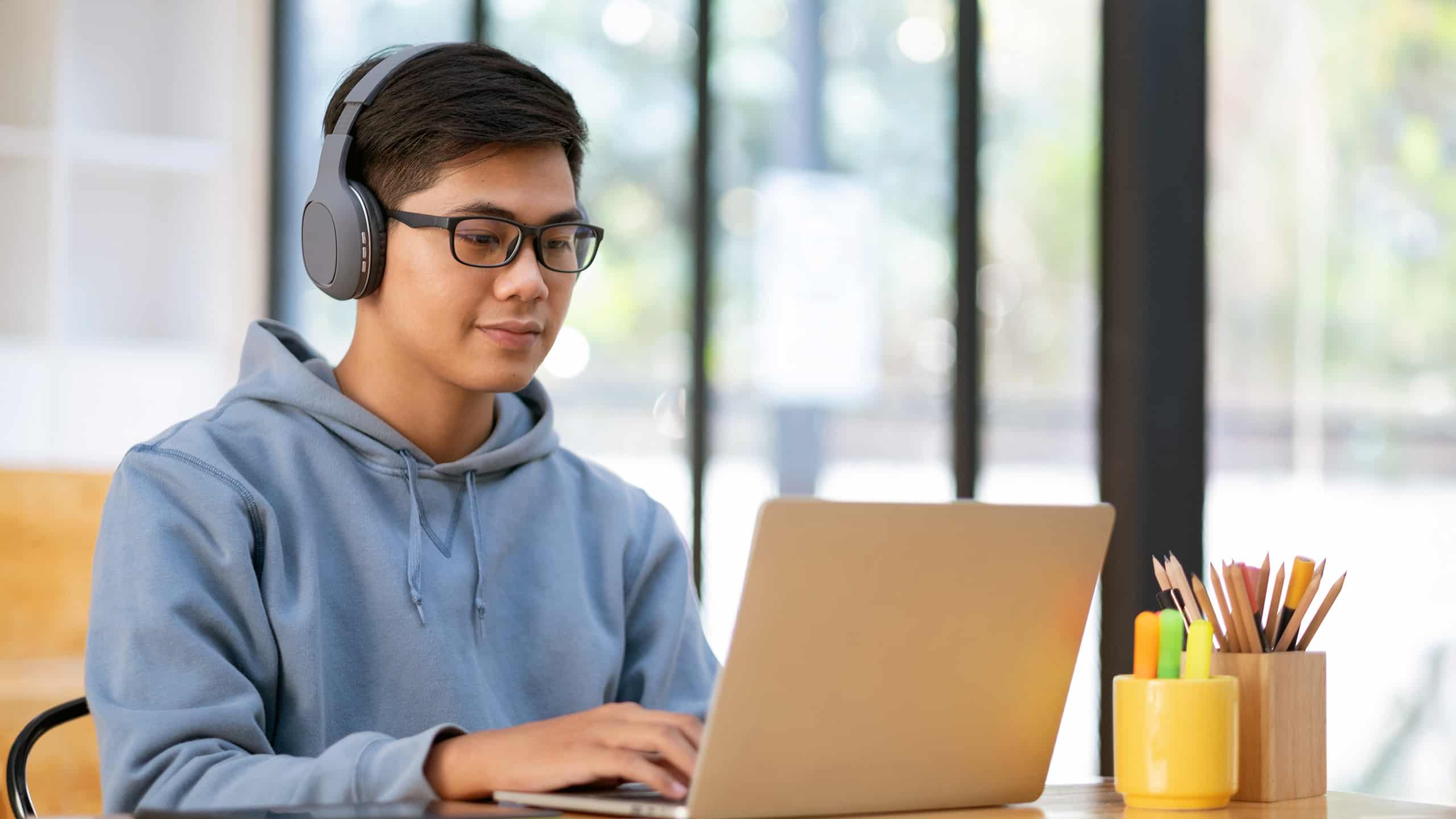 An OR student sitting at a laptop working on his research project.