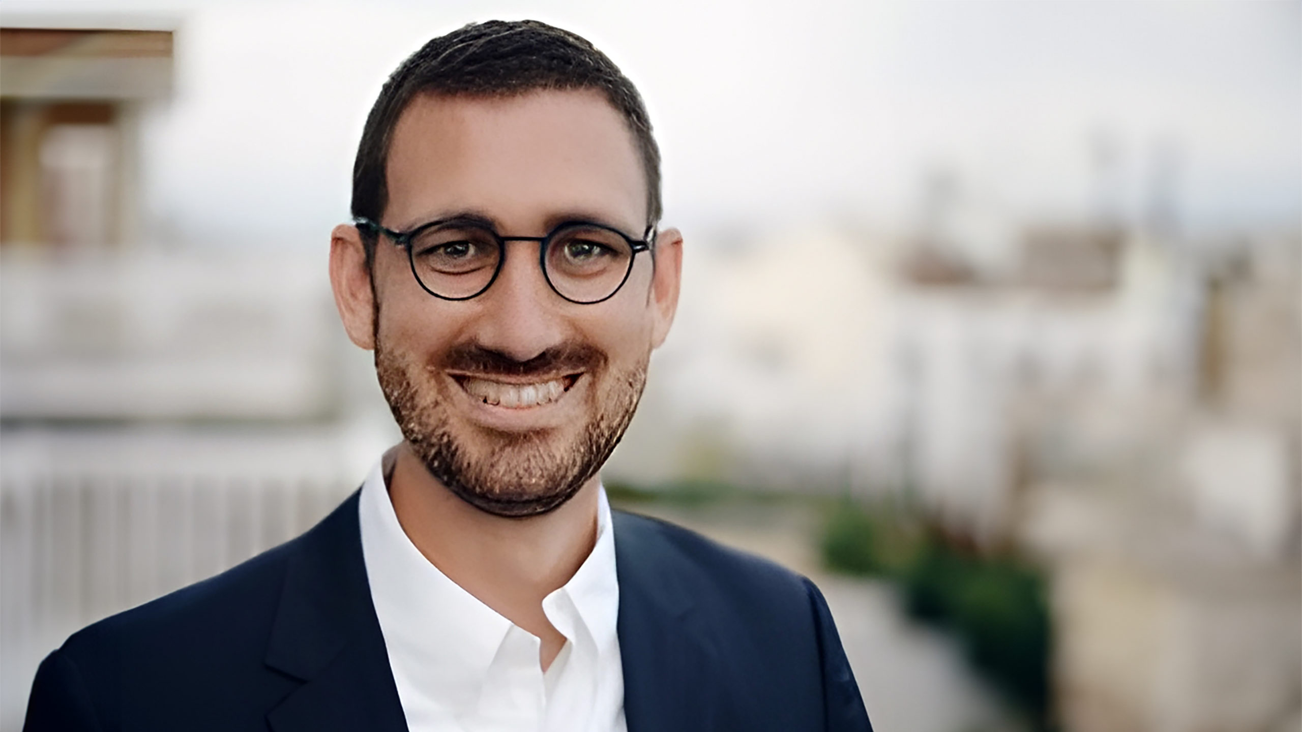 A headshot of David Cornejo standing outside.