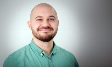 A headshot of Tyler Kroon standing in front of a white background.