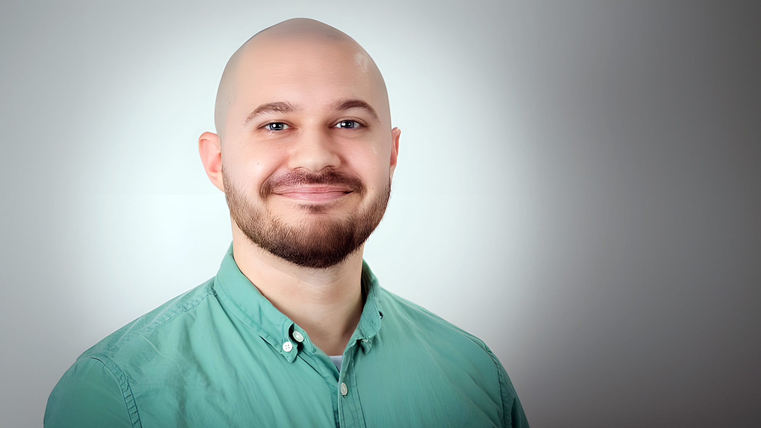 A headshot of Tyler Kroon standing in front of a white background.