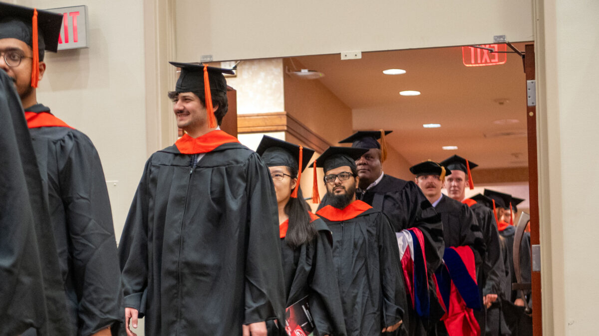 OR Students walking into the commencement ceremony.