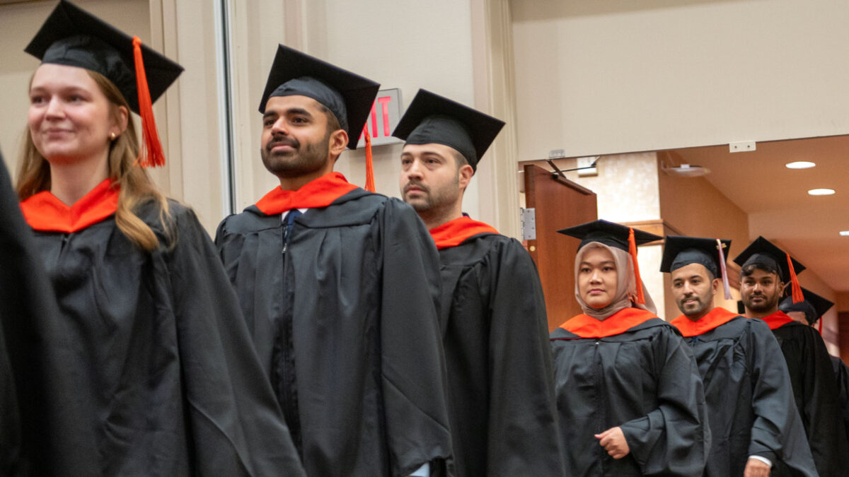 OR Students walking into the commencement ceremony.