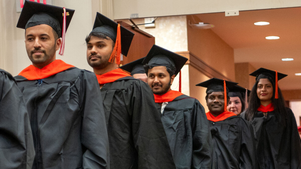 OR Students walking into the commencement ceremony.