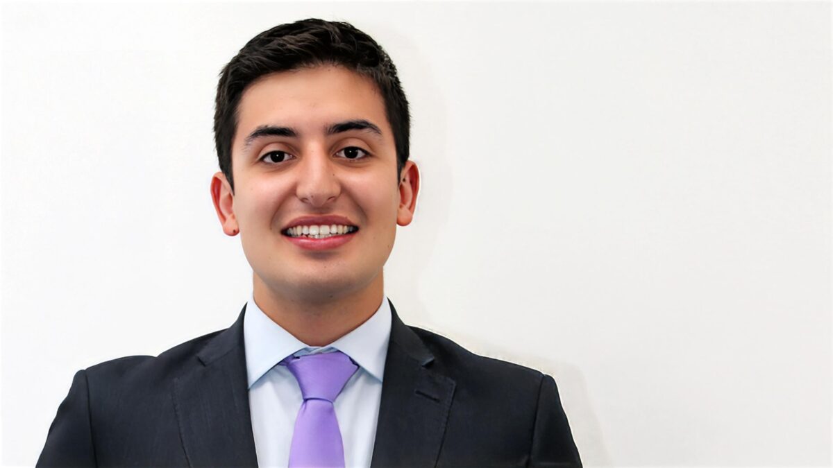 A headshot of David Neira standing in front of a white background.