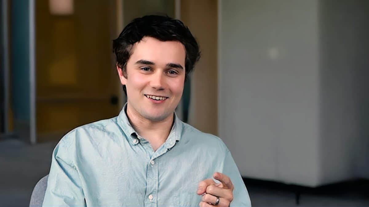 A headshot of Greg Hauser sitting in a conference room.