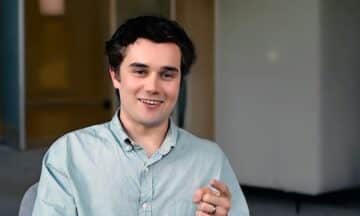 A headshot of Greg Hauser sitting in a conference room.