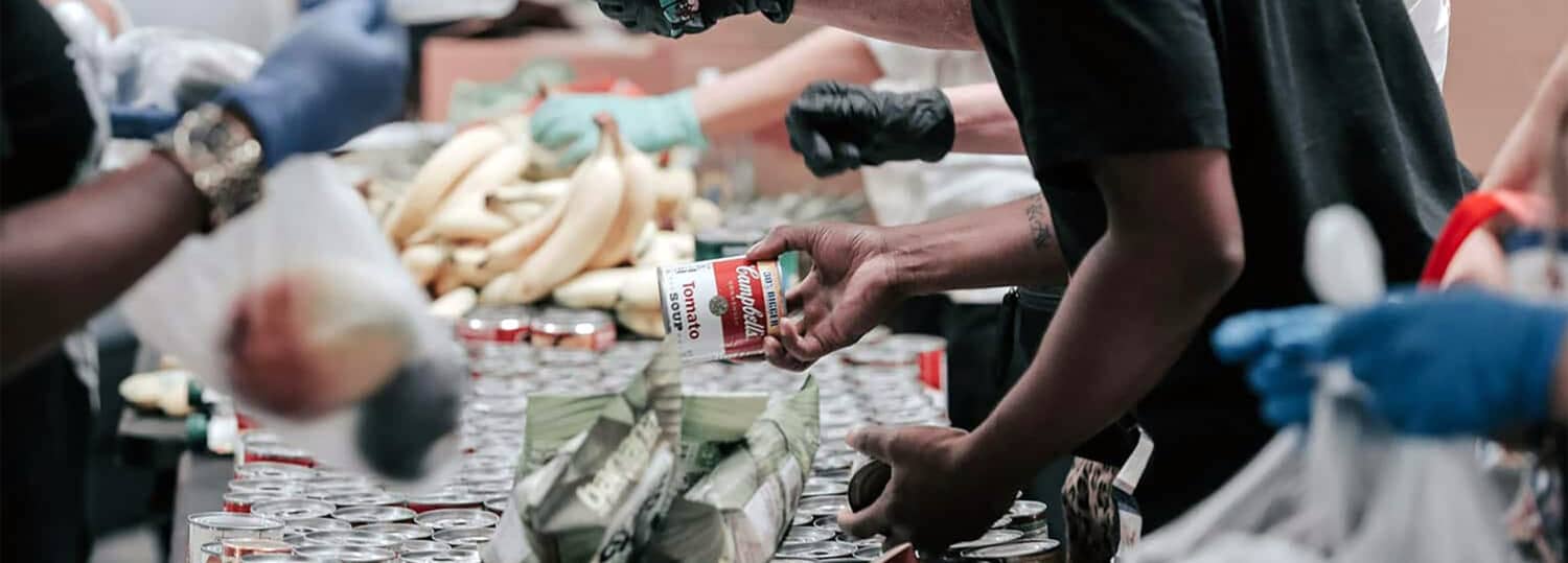 Several volunteers sorting food at a food bank