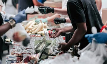 Several volunteers sorting food at a food bank