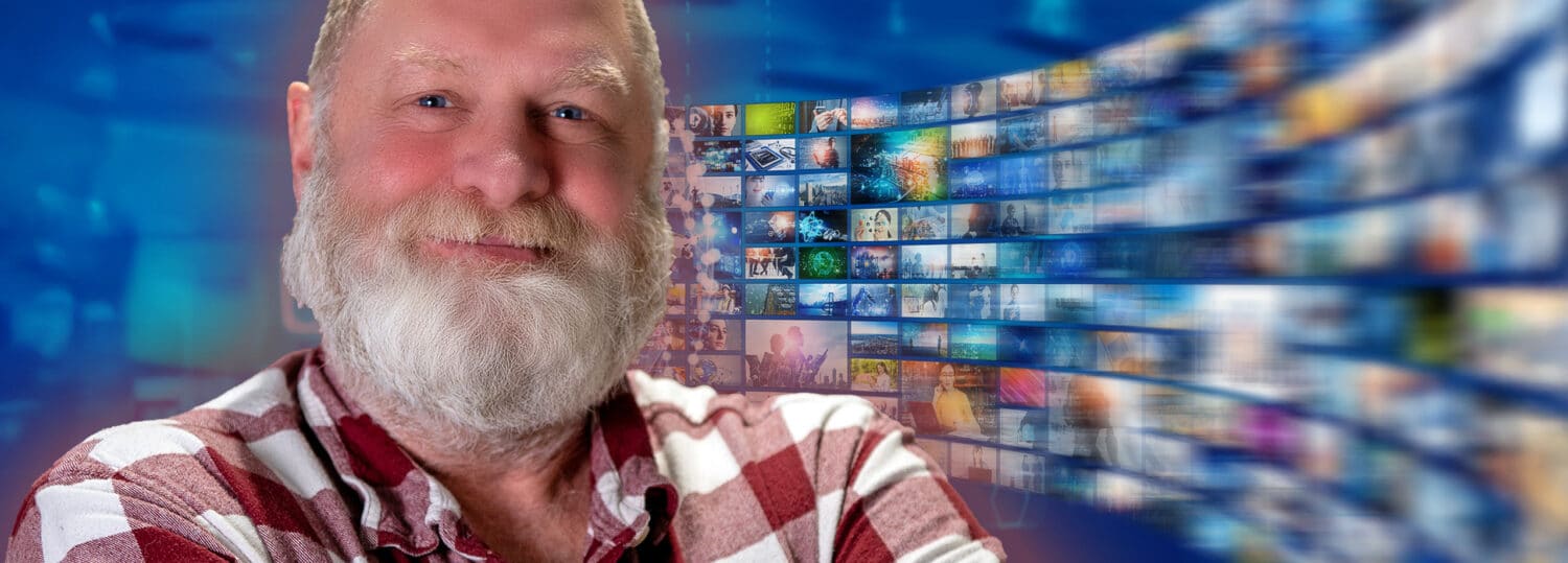 A headshot of Rob with a flow of TV news screens behind him