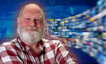 A headshot of Rob with a flow of TV news screens behind him