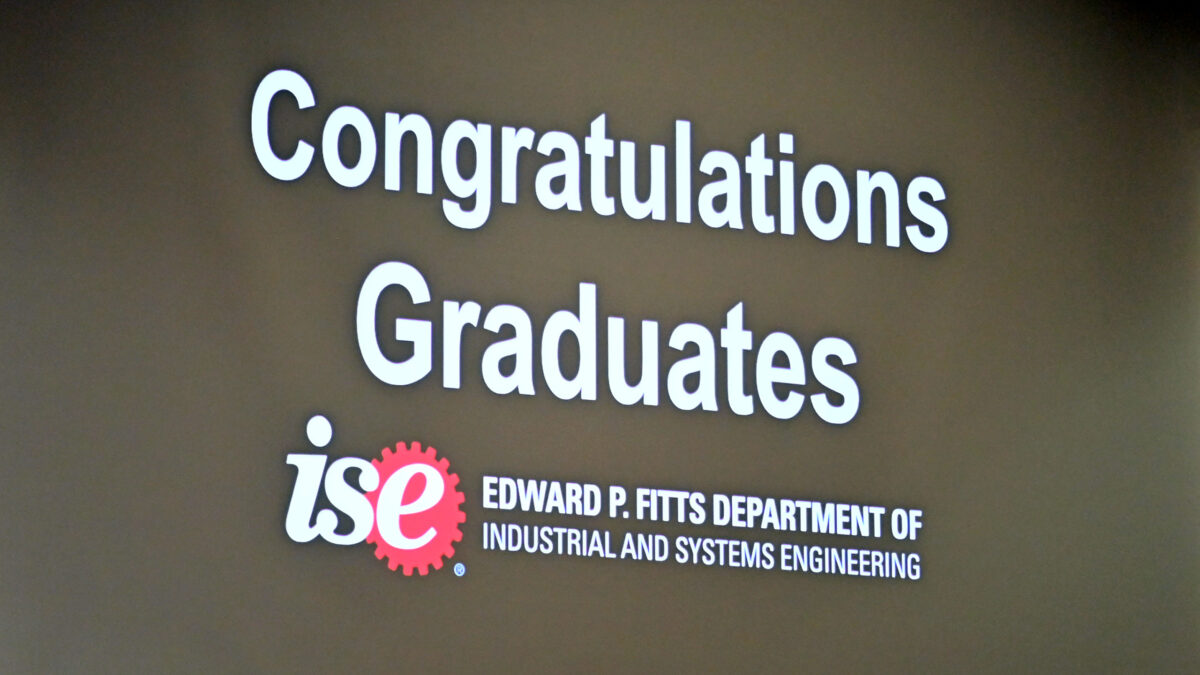 A congratulations message to the OR graduates shown on a giant screen