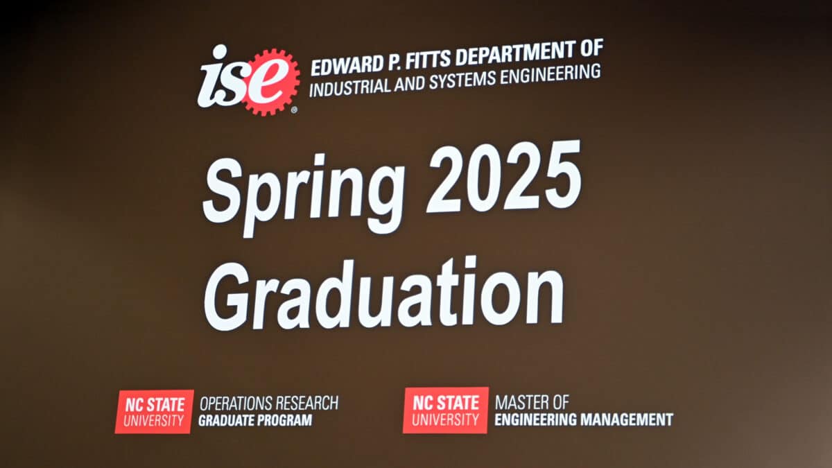A welcome message to the OR Spring 2025 Graduation Ceremony shown on a giant screen