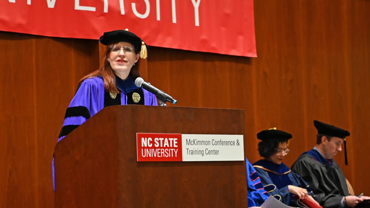 ISE Department Head Julie Swann standing at the podium welcoming everyone to graduation