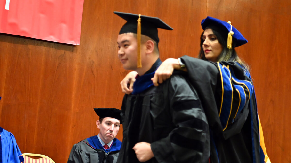 OR Ph.d. student, Kuangying Li gets hooded by his advisor Leila Hajibabai