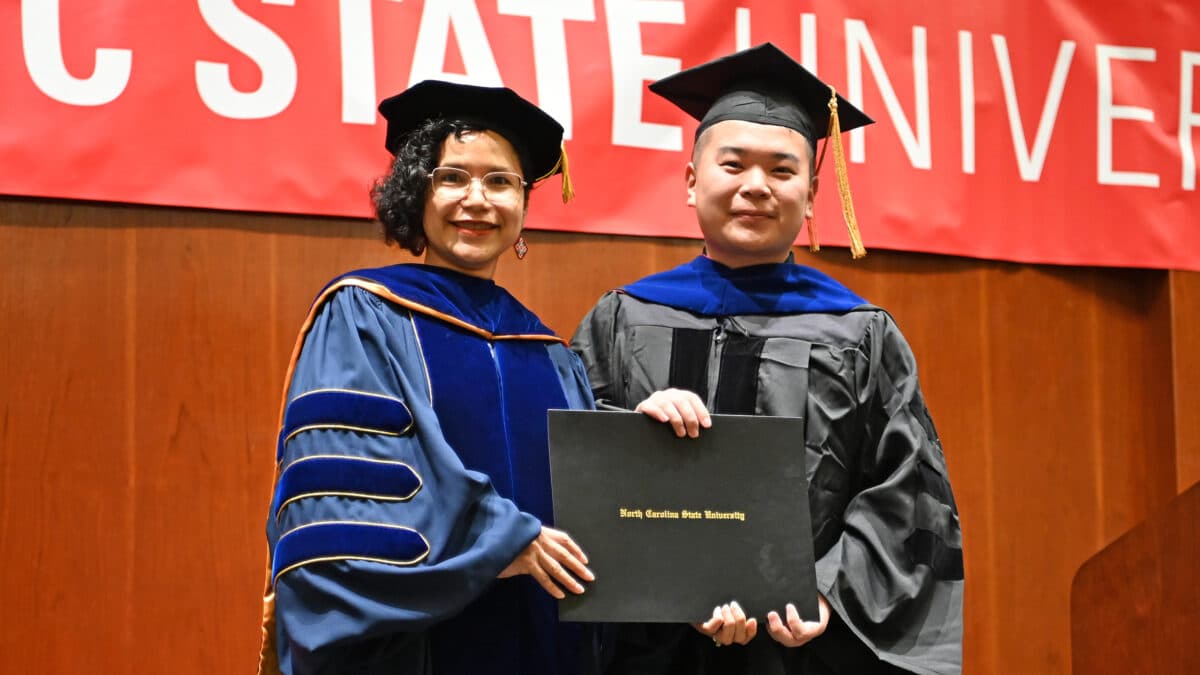 OR Ph.D. student, Kuangying Li, poses with OR Director, Maria Mayorga, as he receives his degree