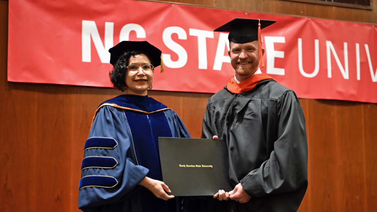 OR MSOR student, Warren Kay,, poses with OR Director, Maria Mayorga, as he receives his degree