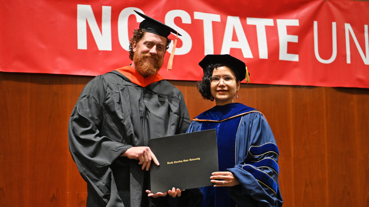 OR MSOR student, Patrick Leavitt, poses with OR Director, Maria Mayorga, as he receives his degree
