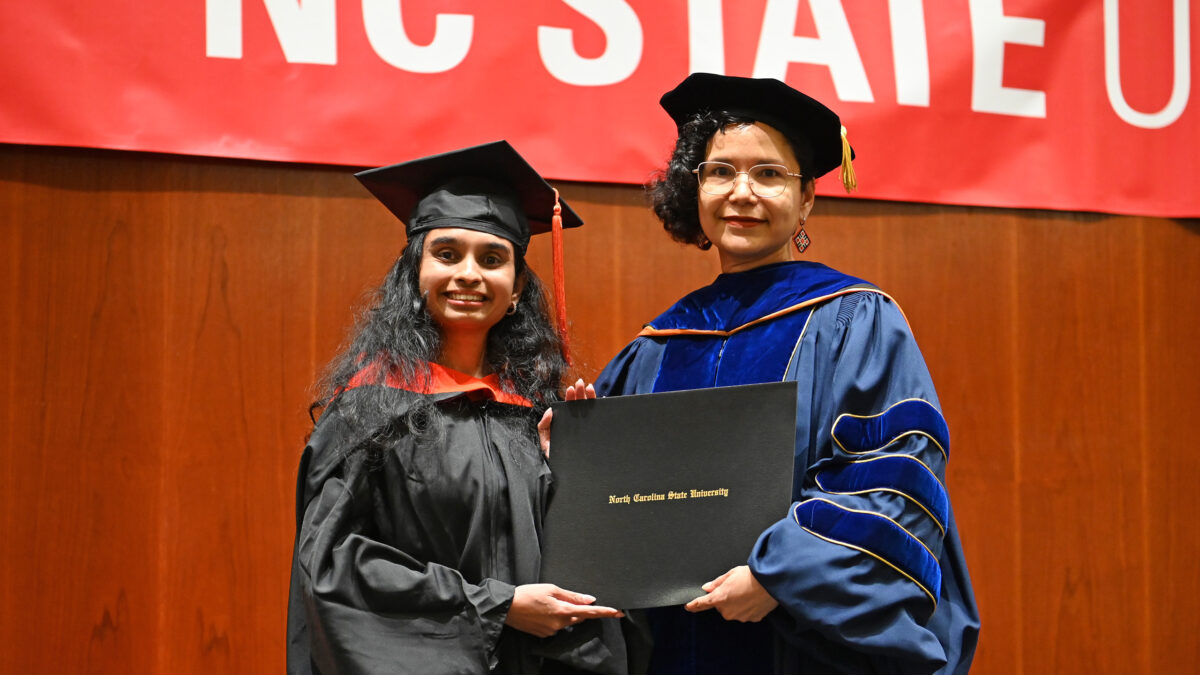 OR MOR student, Netra Madle, poses with OR Director, Maria Mayorga, as she receives her degree