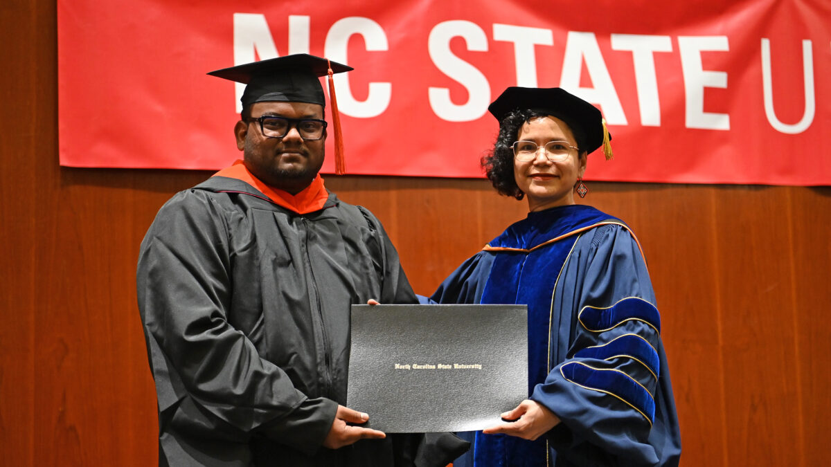 OR MOR student, Sai Puppala, poses with OR Director, Maria Mayorga, as he receives his degree